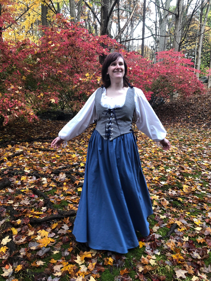 Woman in fall-like setting wearing period costume