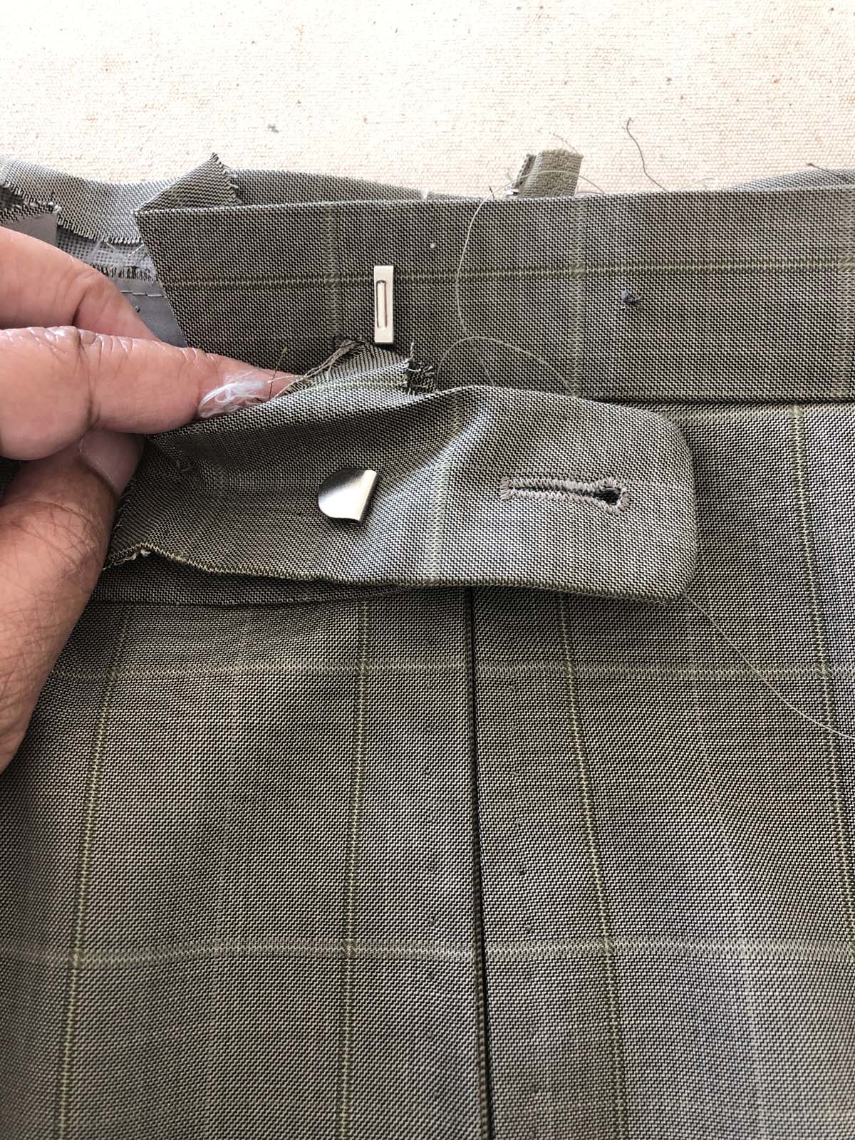 Close-up of men's suit pants waistband back with original closure