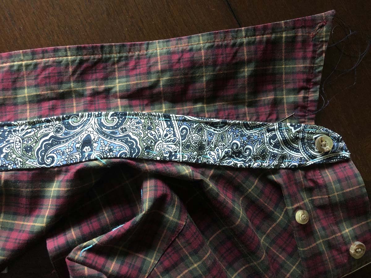 Blouse collar band appliqued to the shirt collar band