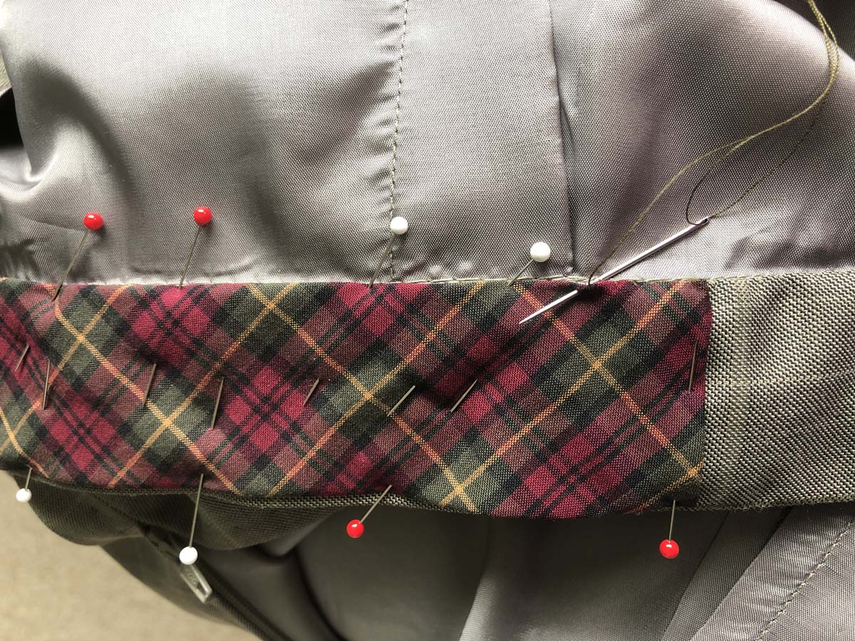 Bias strip cut from the plaid shirt pinned and sewn to the waistband, which originated from men's suit pants