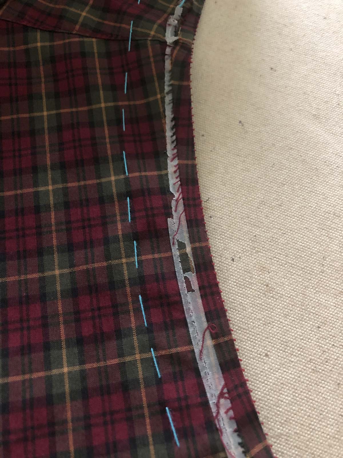 Manufacturer used basting tape to match the plaids