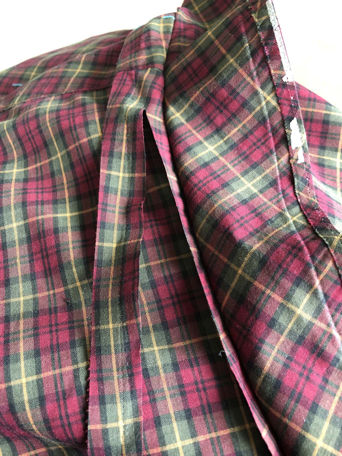 Underseam allowance cut away to prepare for flat-felling the seam