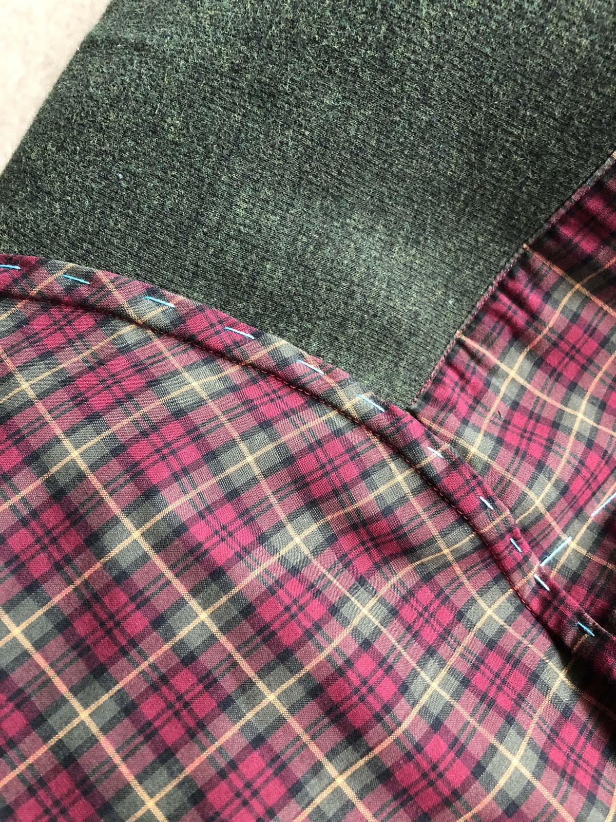 Hand-basted flat-felled seam at the sleeve cap