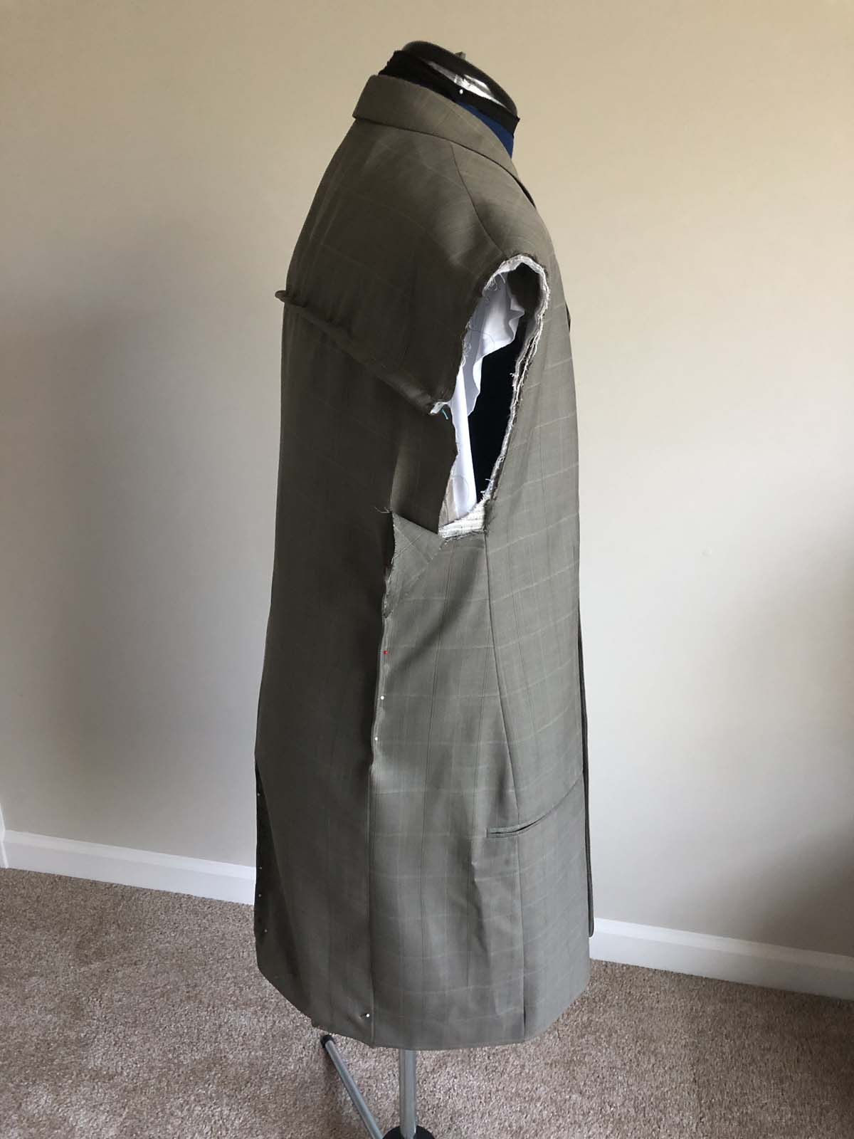 More fitting and draping on the men's suit jacket