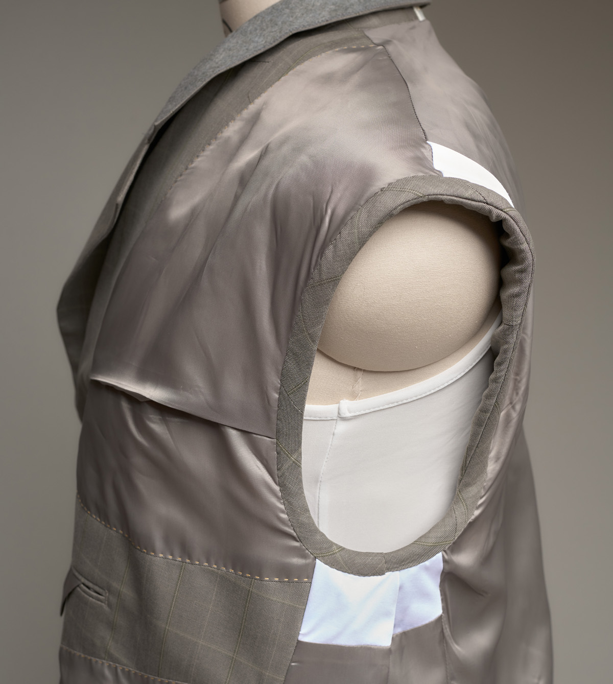 Hand-fell-stitched armhole on women's jacket, created from men's suit
