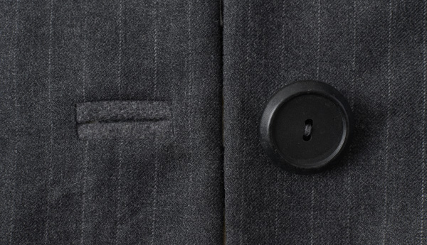 Bound buttonhole and button on woen's suit, made from 1990s men's suit