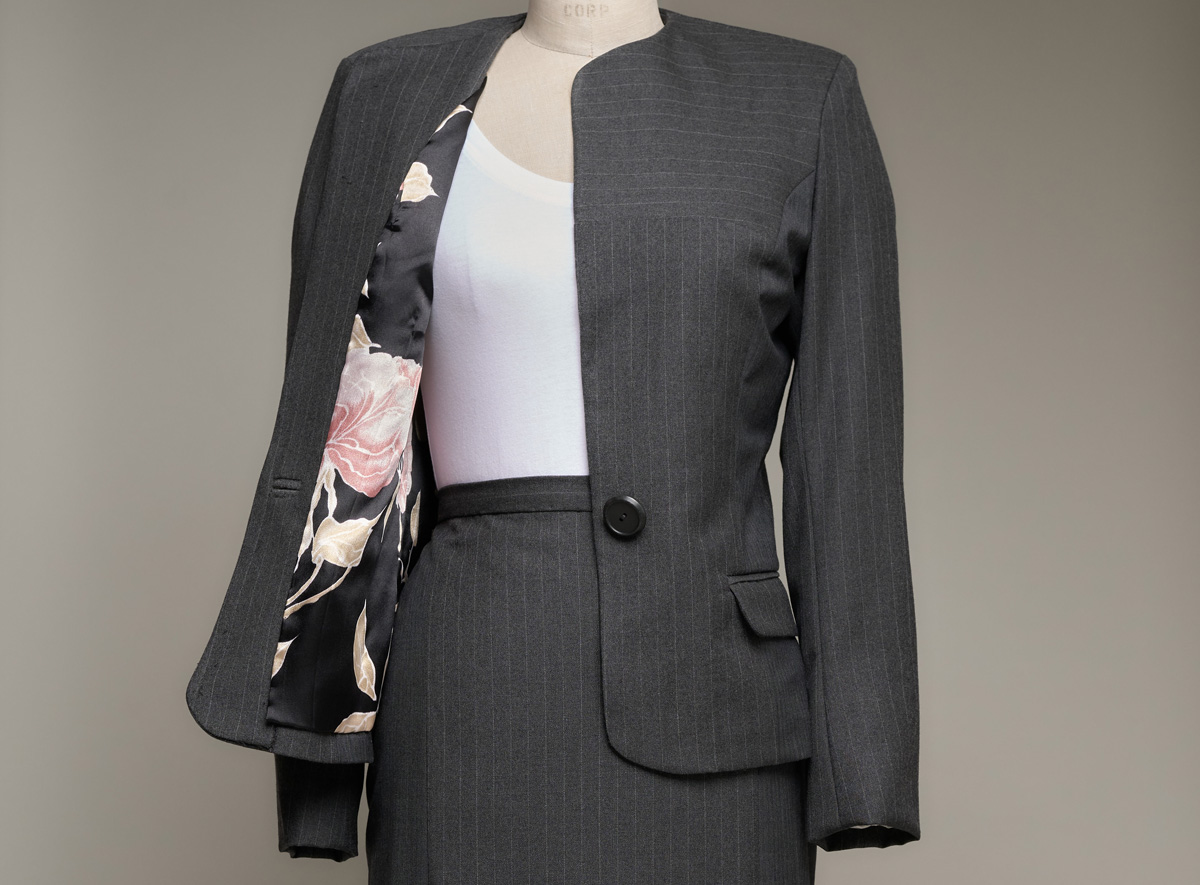 Women's suit jacket on dress form opened to reveal floral lining