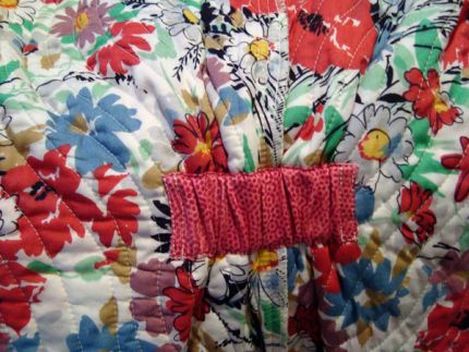 A small piece of elastic, hidden in an inside casing, nips in the waist for a little shape.