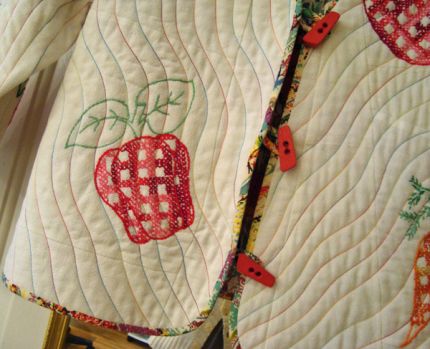 The narrow bias binding and loop buttonholes are cut from a piece of colorful quilter's cotton fabric.